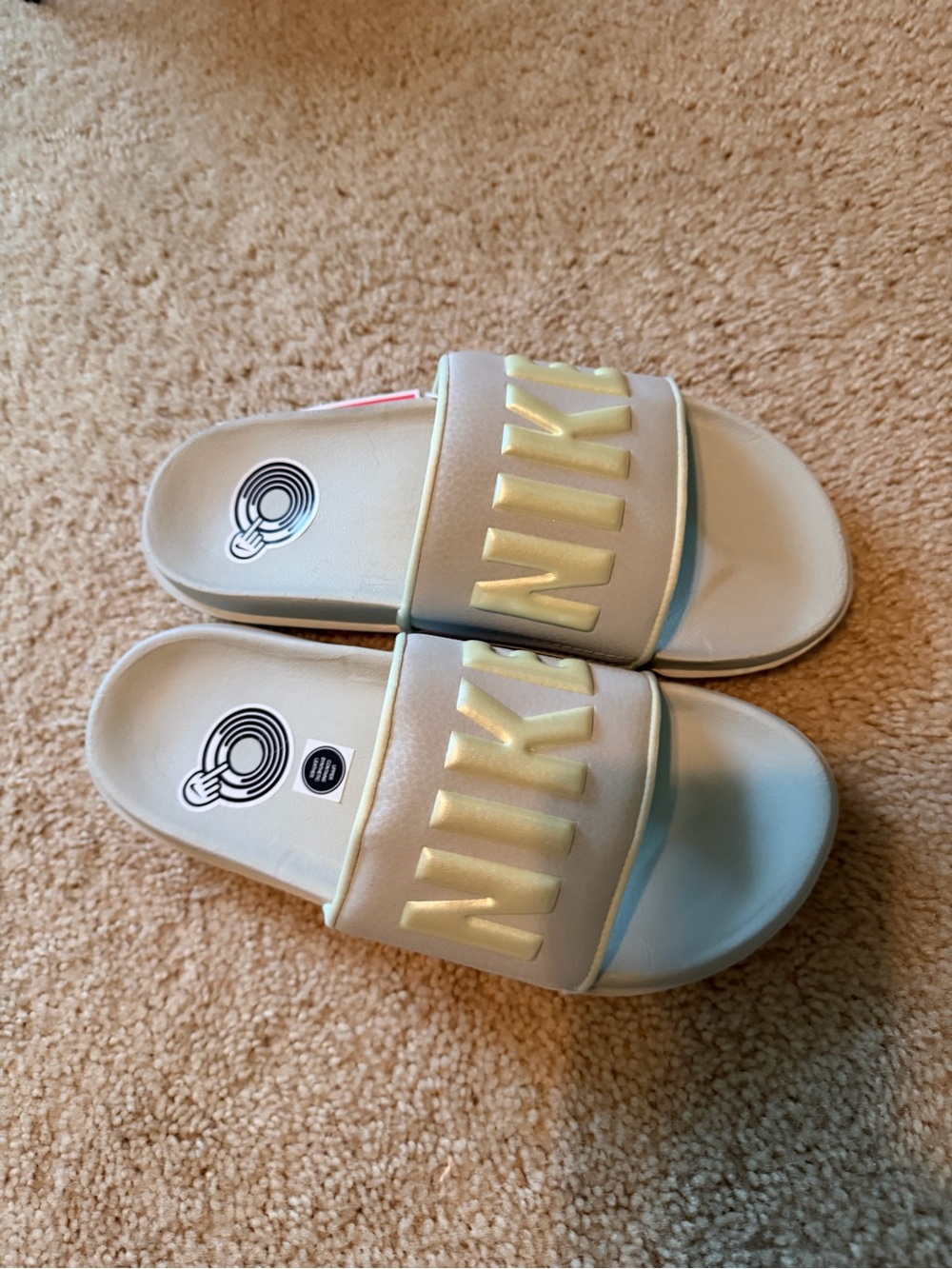 Nike Women’s Slide Sandals in Light Gray with Gold Logo - Picture 2 of 3